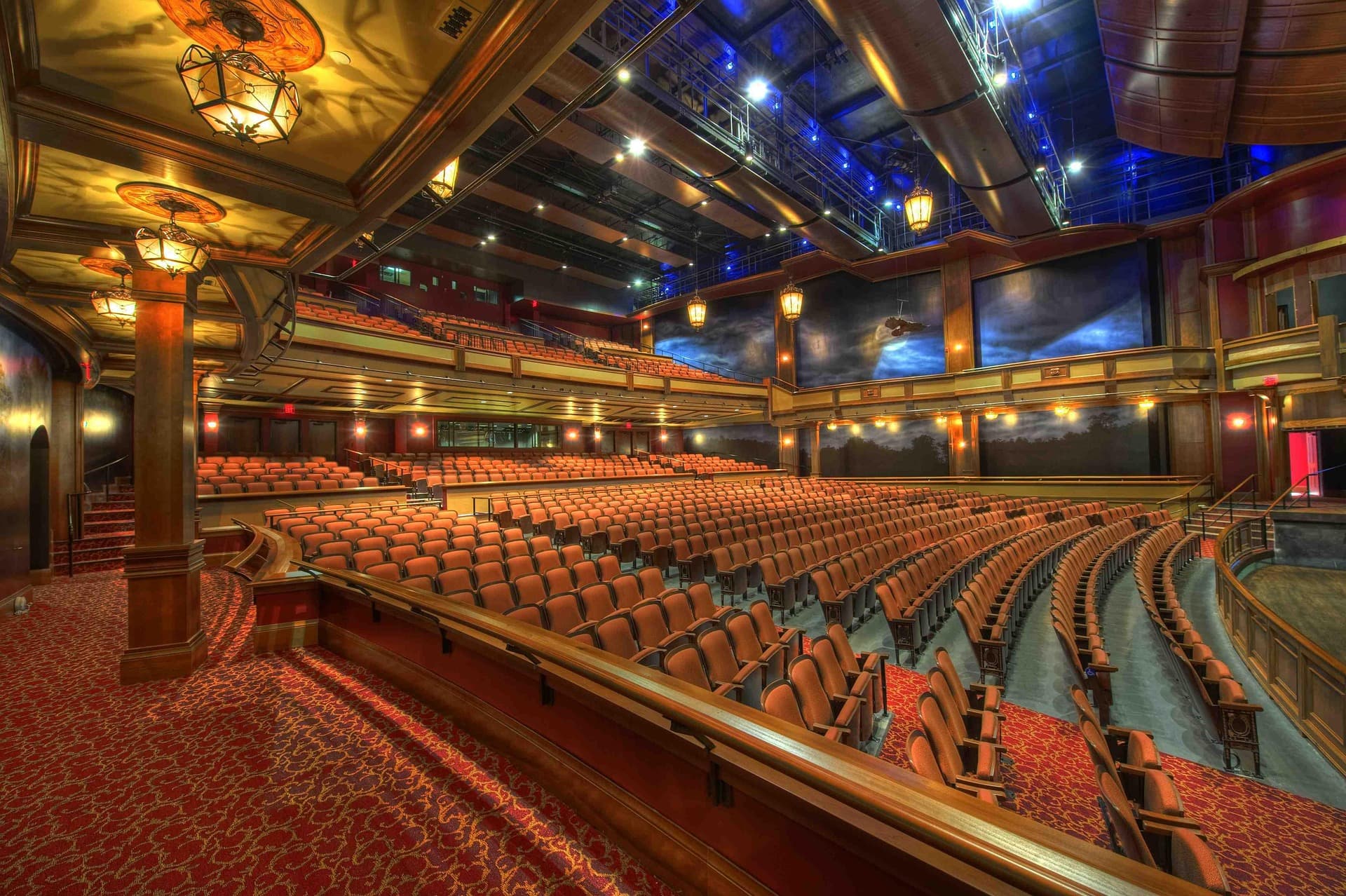 Grand theater auditorium with ornate carpeting and seating maintained to immaculate standards