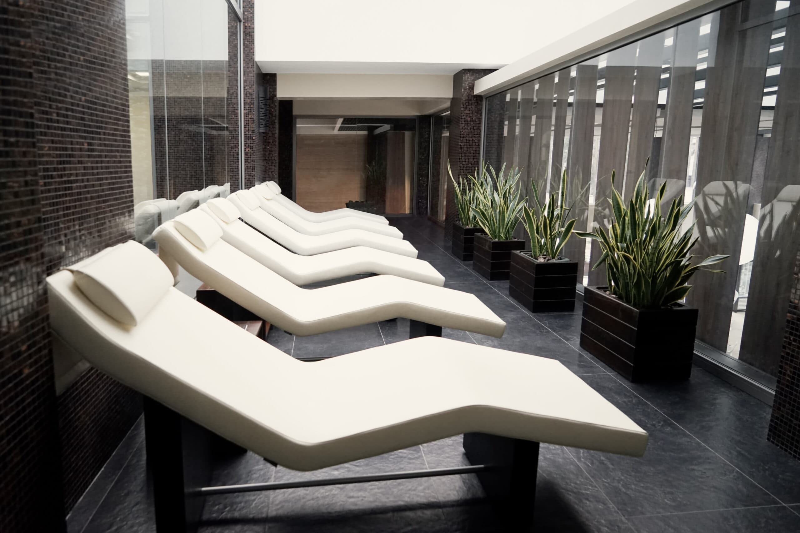 Upscale property amenity lounge with spa chairs and plants maintained by Space Care