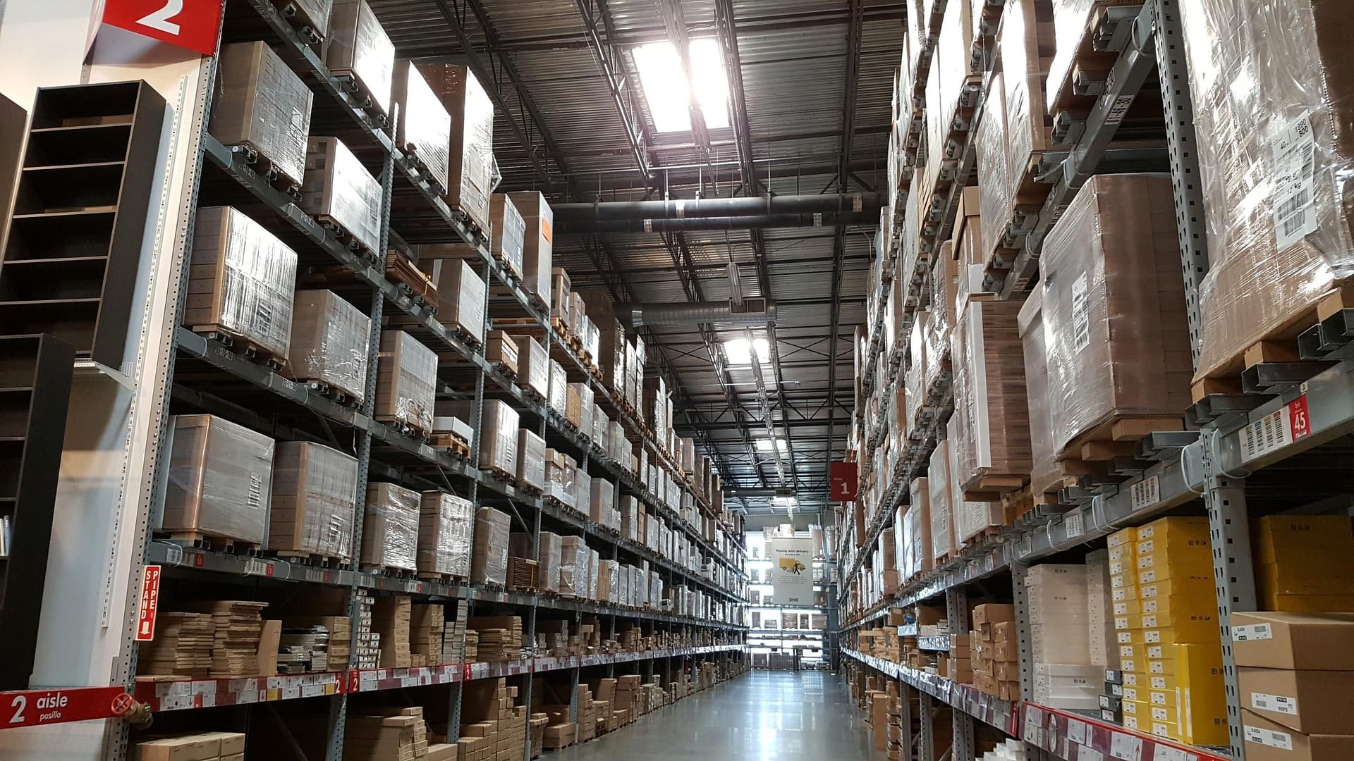 Large warehouse interior with tall shelving racks stocked with inventory
