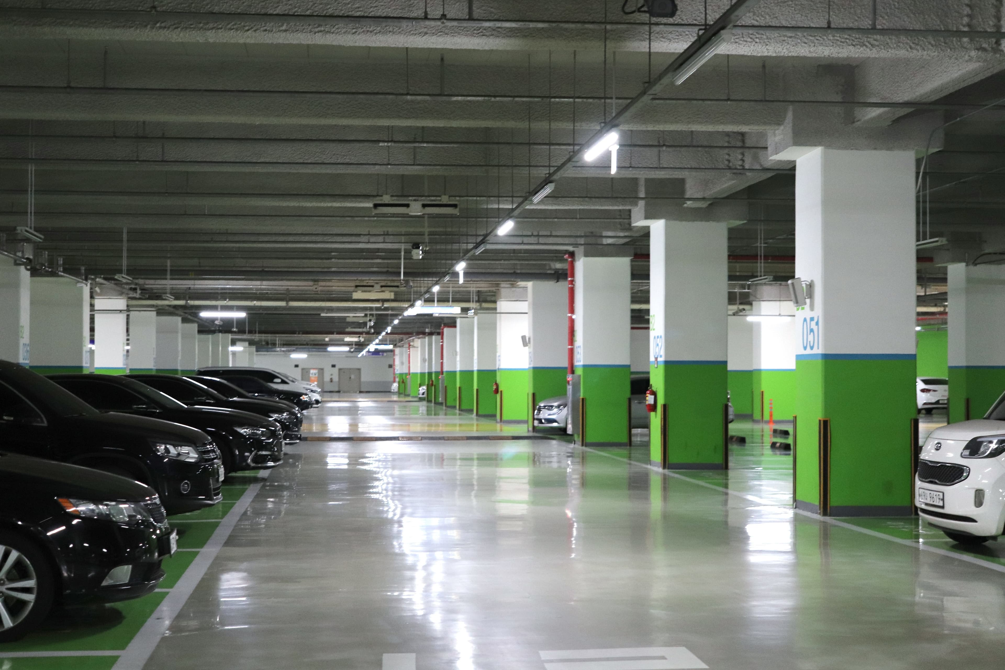 Clean, well-lit underground parking garage with polished floors and organized spaces