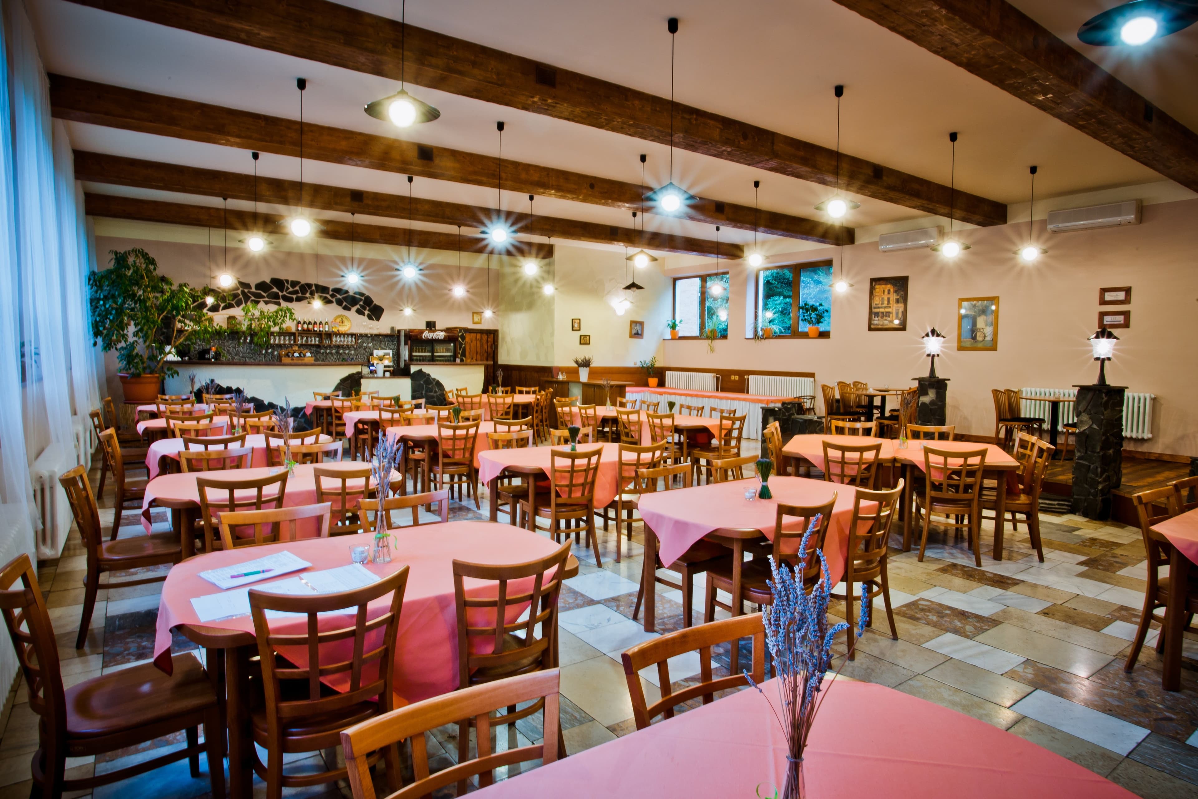 Clean restaurant dining room with set tables ready for guests — protected by commercial pest management