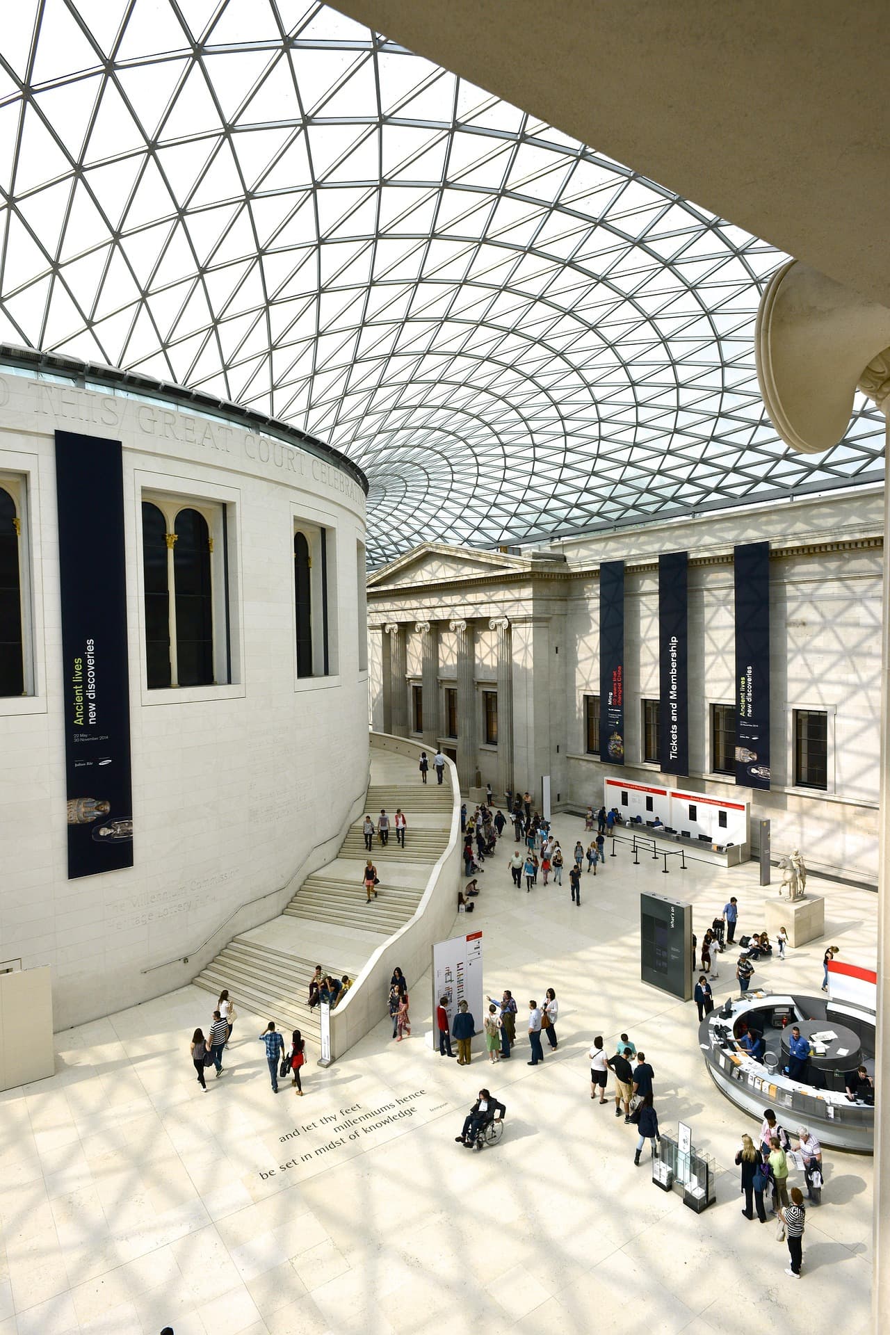 Bright museum great hall with polished stone floors and skylit commercial interior